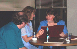 David, Miriam, and Shari sit and look through one of the yearbooks that showed up at the dance