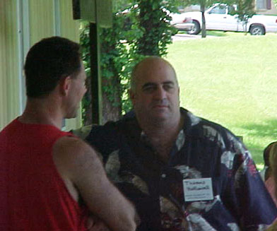 Mark and Thomas talk as they sit out on the patio