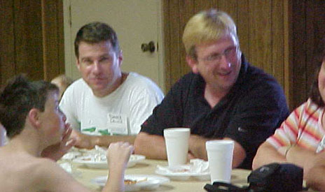 Brother-in-laws David and Terry sit with their family as they finish up lunch